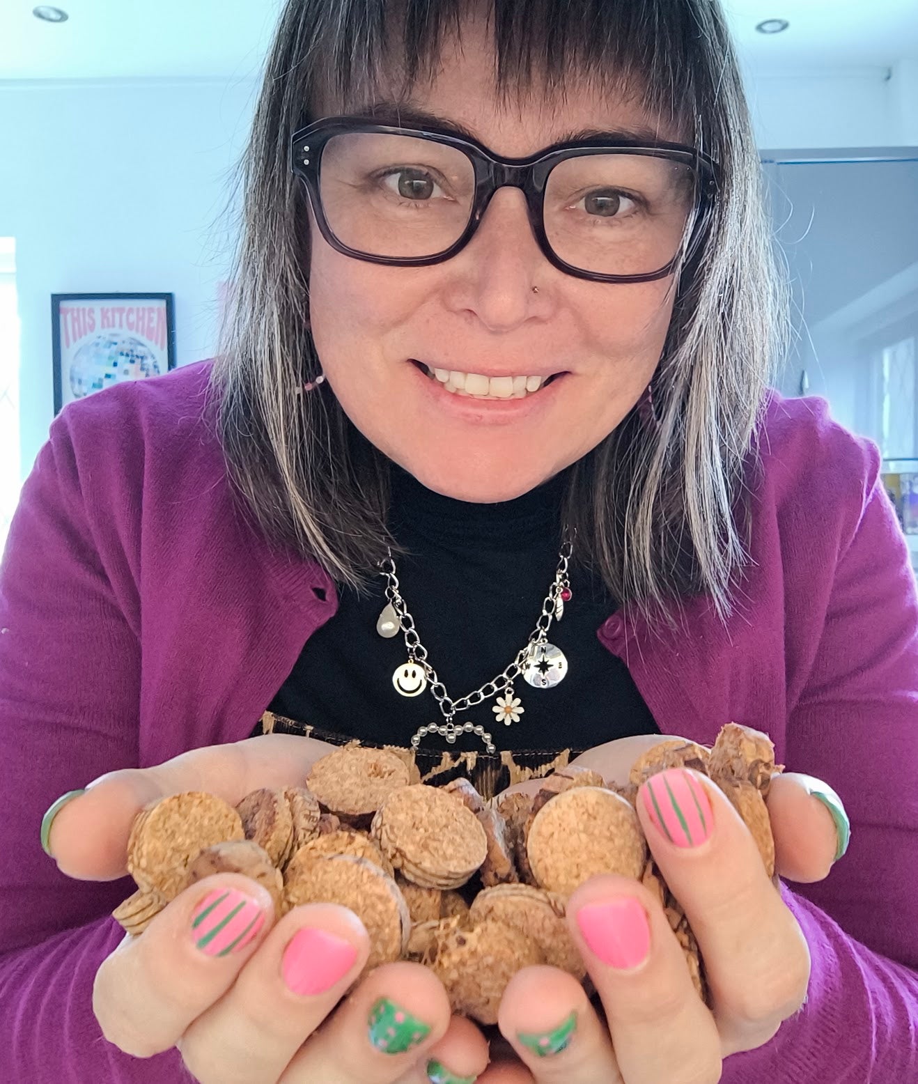 Kirsty holding out a double handful of small cork discs
